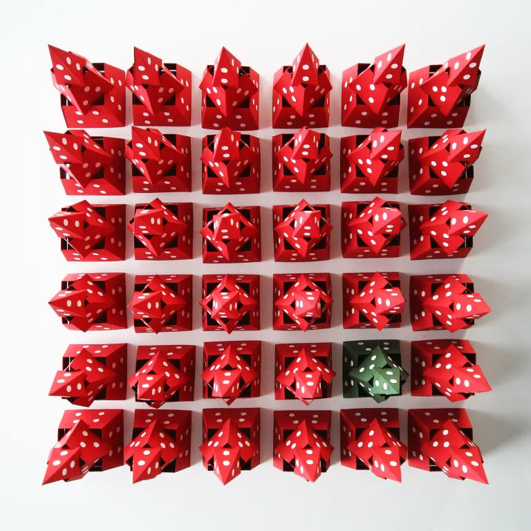 Grid of red paper origami boxes with white dots on a white background