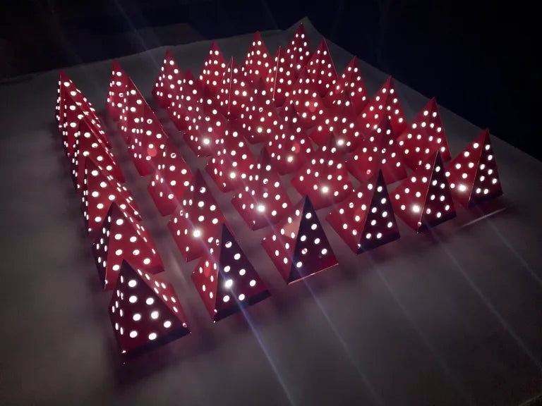 Red decorative elements with white polka dots on a dark background